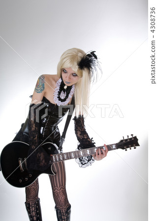 Sexy gothic girl playing guitar 4308736
