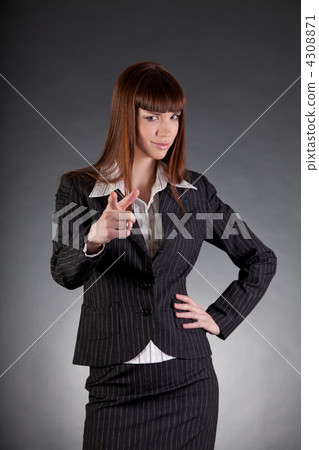 Serious looking business woman pointing in camera Serious looking business woman pointing in camera 4308871