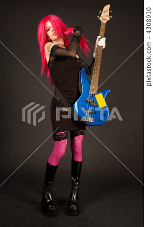 Attractive girl putting on bass guitar 4308910
