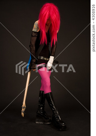 Attractive girl with guitar putting on stocking 4308916