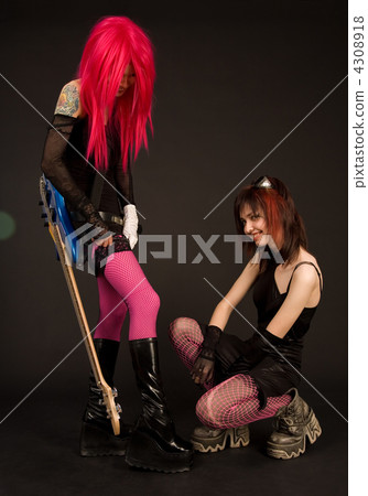 Attractive girl with guitar putting on stocking 4308918