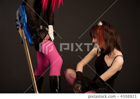 Girl with guitar putting on stocking 4308921