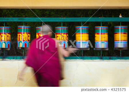 Buddhist monk rotating prayer wheels in McLeod Ganj 4325575