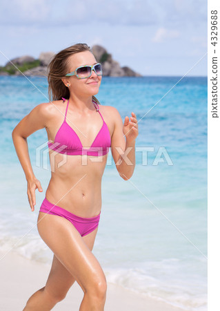 Woman Running Along The Beach Woman Running Along The Beach 4329688