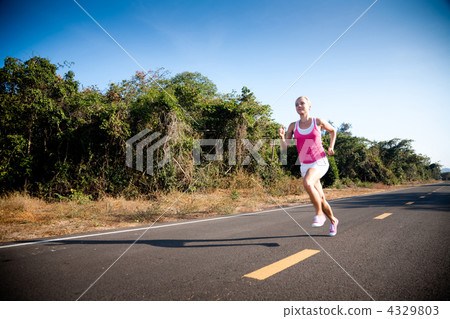 Blond woman running cross country Blond woman running cross country 4329803