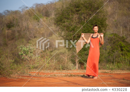 Beautiful girl dressed  terracotta dress with a scarf in her han 4330228