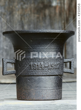 Ancient kitchen and medical utensil. Old metal mortar on wooden Ancient kitchen and medical utensil. Old metal mortar on wooden 4350958