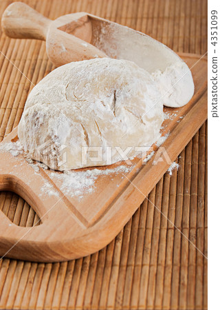 Bakery ingredient. Flour in spoon and fresh dough for making bre 4351099