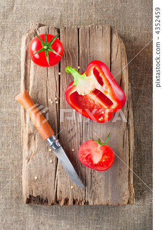 Fresh tomato, paprika, steel knife and vintage wooden cutting bo Fresh tomato, paprika, steel knife and vintage wooden cutting bo 4352459