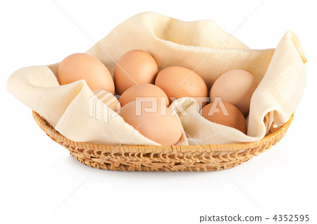 Macro of brown eggs in wooden basket on linen canvas. White back Macro of brown eggs in wooden basket on linen canvas. White back 4352595