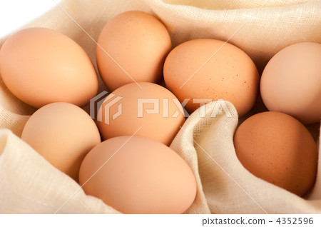 Macro of brown eggs on linen canvas. White background, shallow d Macro of brown eggs on linen canvas. White background, shallow d 4352596