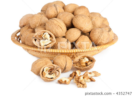 Walnuts in wooden basket on the white background Walnuts in wooden basket on the white background 4352747