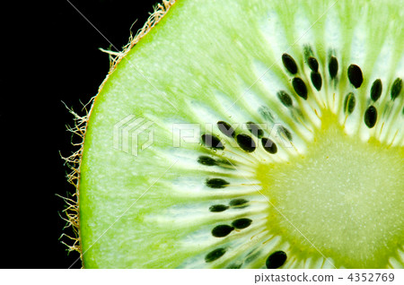 Macro of slim sliced kiwi fruit on black background 4352769