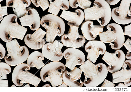 Sliced champignon mushrooms on black 4352771