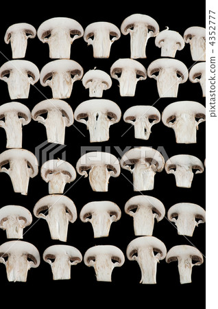Sliced champignon mushrooms on black 4352777
