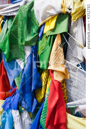 Buddhist prayer stone with written mantra and praying flags 4352781