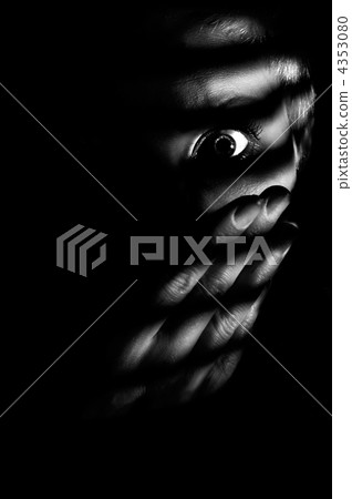 Low key concept photo of woman looking through window jalousies 4353080