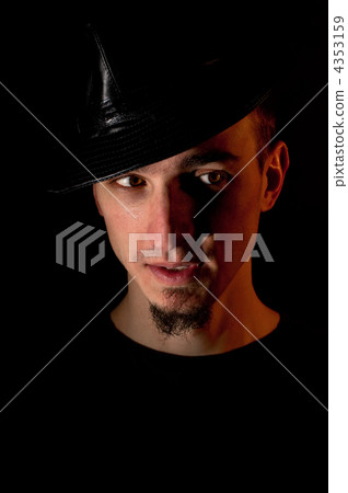 Studio portrait of surprised handsome man in hat over black back 4353159