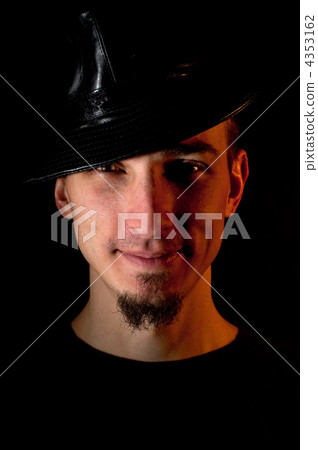 Studio portrait of smiling handsome man in hat over black backgr Studio portrait of smiling handsome man in hat over black backgr 4353162