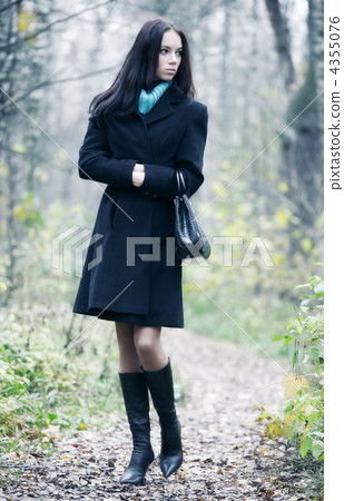 Slim brunette woman walking in a park 4355076