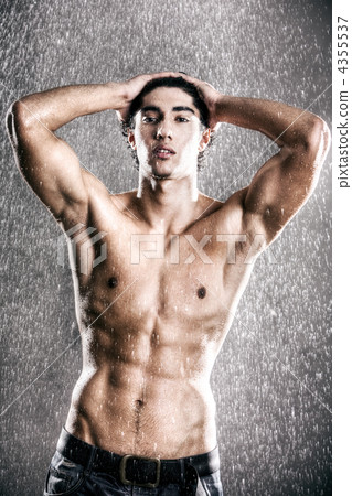 Young muscular man under the rain 4355537