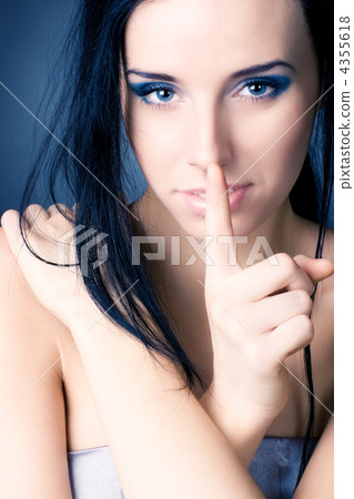 Young woman showing quiet sign Young woman showing quiet sign 4355618
