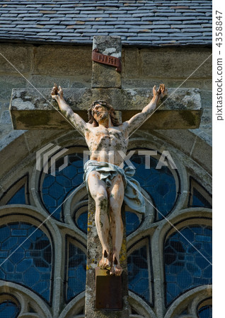 Jesus Christ in a granite cross outside a church 4358847