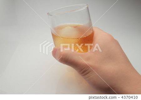 Hand holding a glass with whiskey 4370410