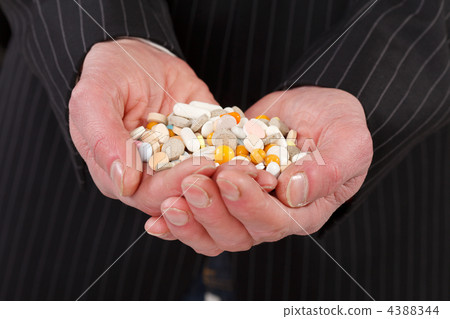 man holding pills 4388344