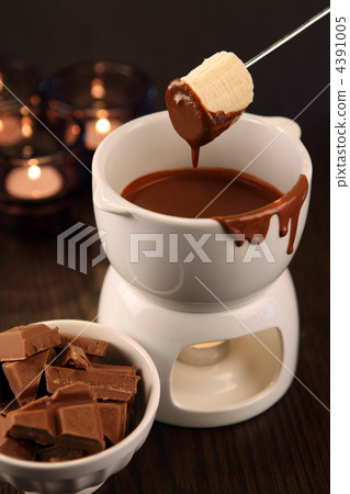 Dipping into chocolate fondue Dipping into chocolate fondue 4391005