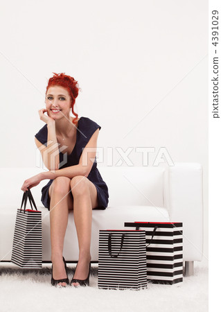 Beautiful redhead with shopping bags 4391029