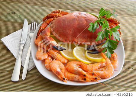 Crab with shrimp and parsley on a wooden table 4395215