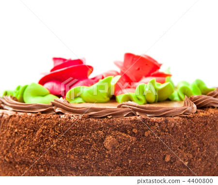 Chocolate cake with two cream-colored roses. Isolated on white background. Chocolate cake with two cream-colored roses. Isolated on white background. 4400800
