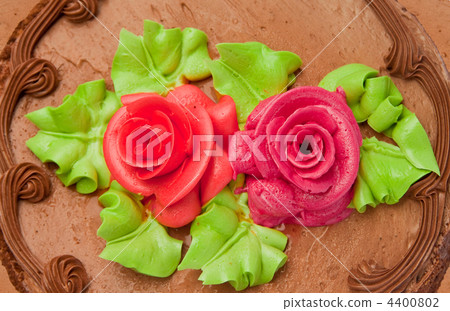Chocolate cake with two cream-colored roses. Isolated on white background. Chocolate cake with two cream-colored roses. Isolated on white background. 4400802