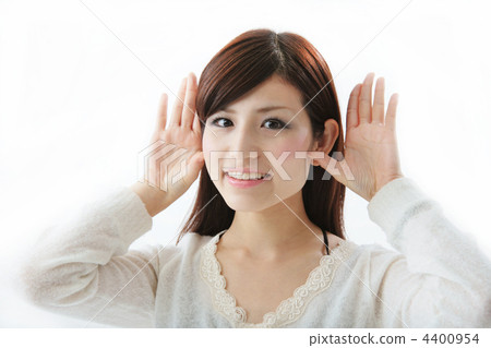 A woman putting her hand on her ear 4400954