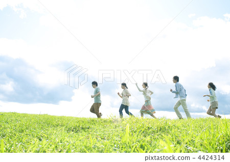 Five young people walking in the meadow Five young people walking in the meadow 4424314