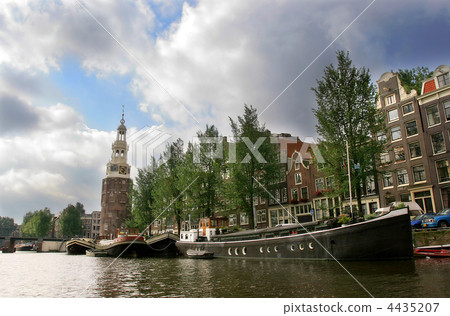 Boats and old historical houses along city canal in Amsterdam. Boats and old historical houses along city canal in Amsterdam. 4435207