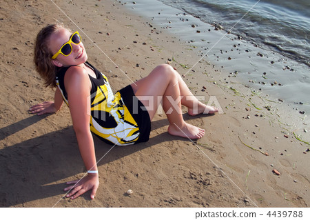 Young girl sitting on the beach. 4439788