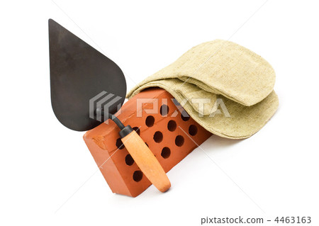 Red perforated ceramic brick, trowel and gauntlet isolated on wh Red perforated ceramic brick, trowel and gauntlet isolated on wh 4463163