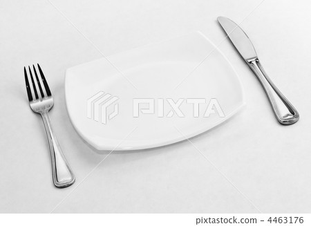 Place setting for one person. Knife, square white plate and fork Place setting for one person. Knife, square white plate and fork 4463176