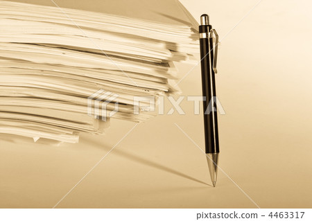 a pen near stack of paper 4463317