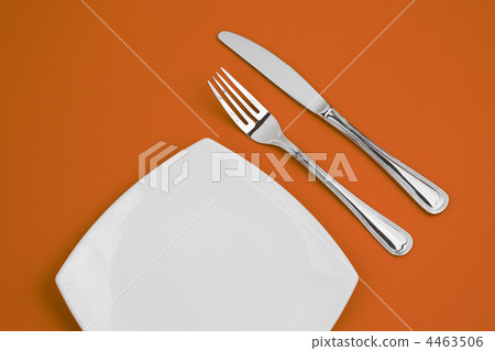 Knife, square white plate and fork on orange background Knife, square white plate and fork on orange background 4463506
