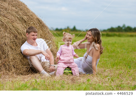 Happy family in haystack or hayrick with watermelon 4466529