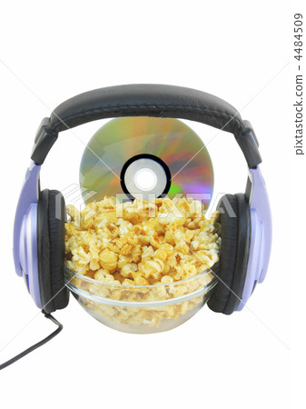 Bowl full of caramel popcorn with DVD disk . Bowl full of caramel popcorn with DVD disk . 4484509