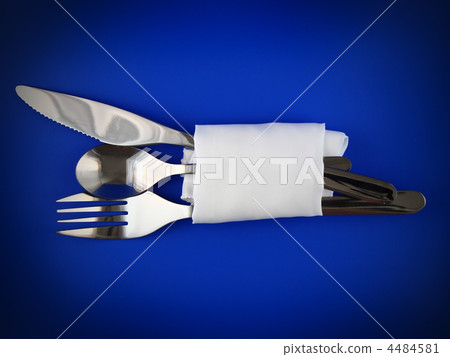 Table serving-knife,spoon,fork on blue backdrop. 4484581