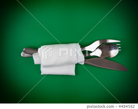 Table serving-knife,spoon,fork on green backdrop. Table serving-knife,spoon,fork on green backdrop. 4484582