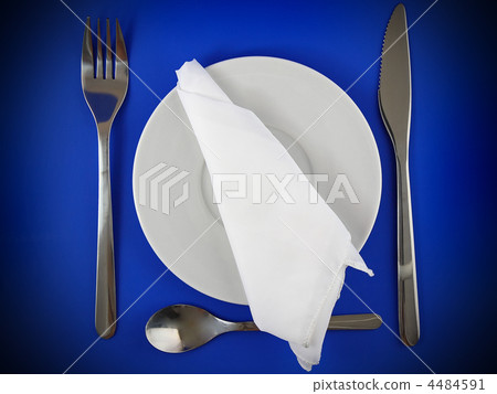 Table serving-knife,spoon,fork on blue backdrop. 4484591