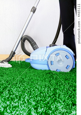 Vacuum cleaner in action - men cleaner a carpet. Vacuum cleaner in action - men cleaner a carpet. 4485111