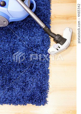 Vacuum cleaner stand  on blue carpet. 4485342