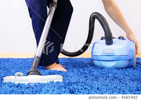 Vacuum cleaner in action-men cleaner a carpet. Vacuum cleaner in action-men cleaner a carpet. 4485402